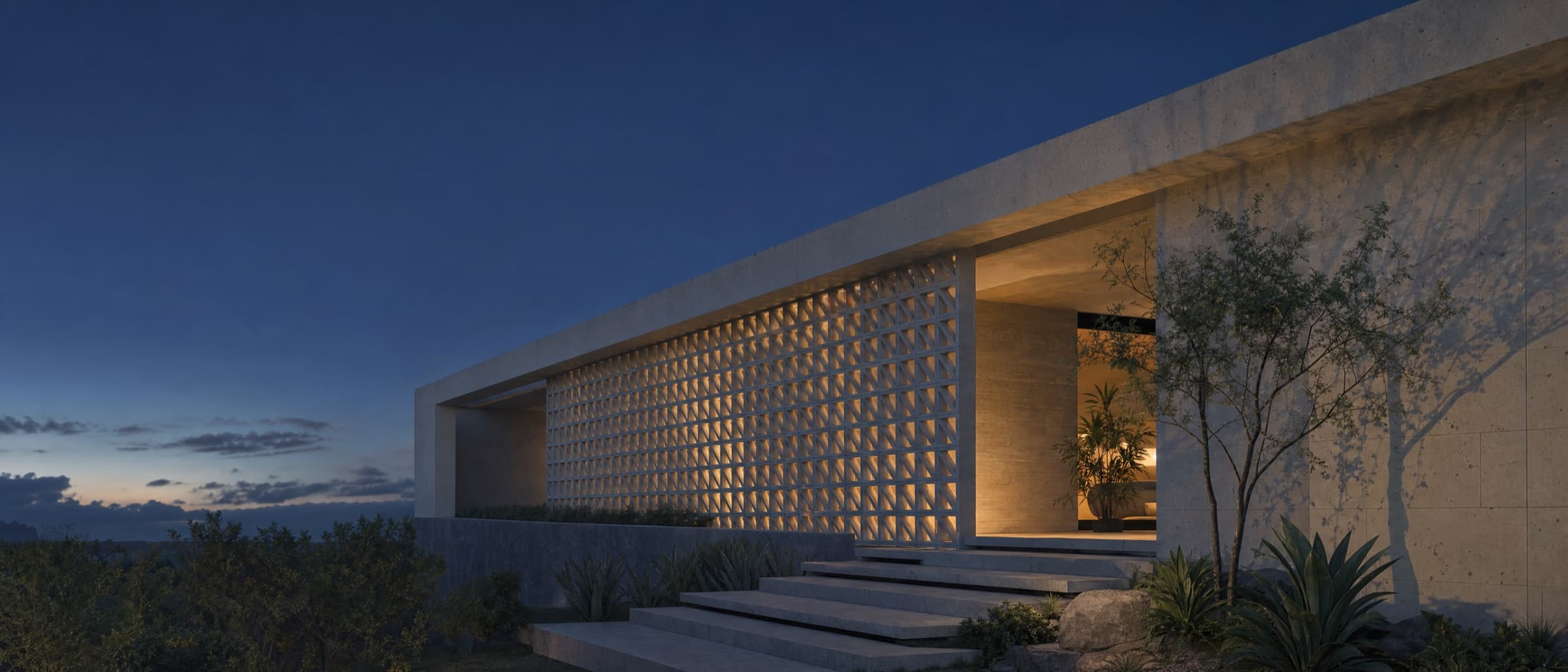 Arquitectura mexicana contemporánea al atardecer, con celosía de cantera iluminada desde el interior